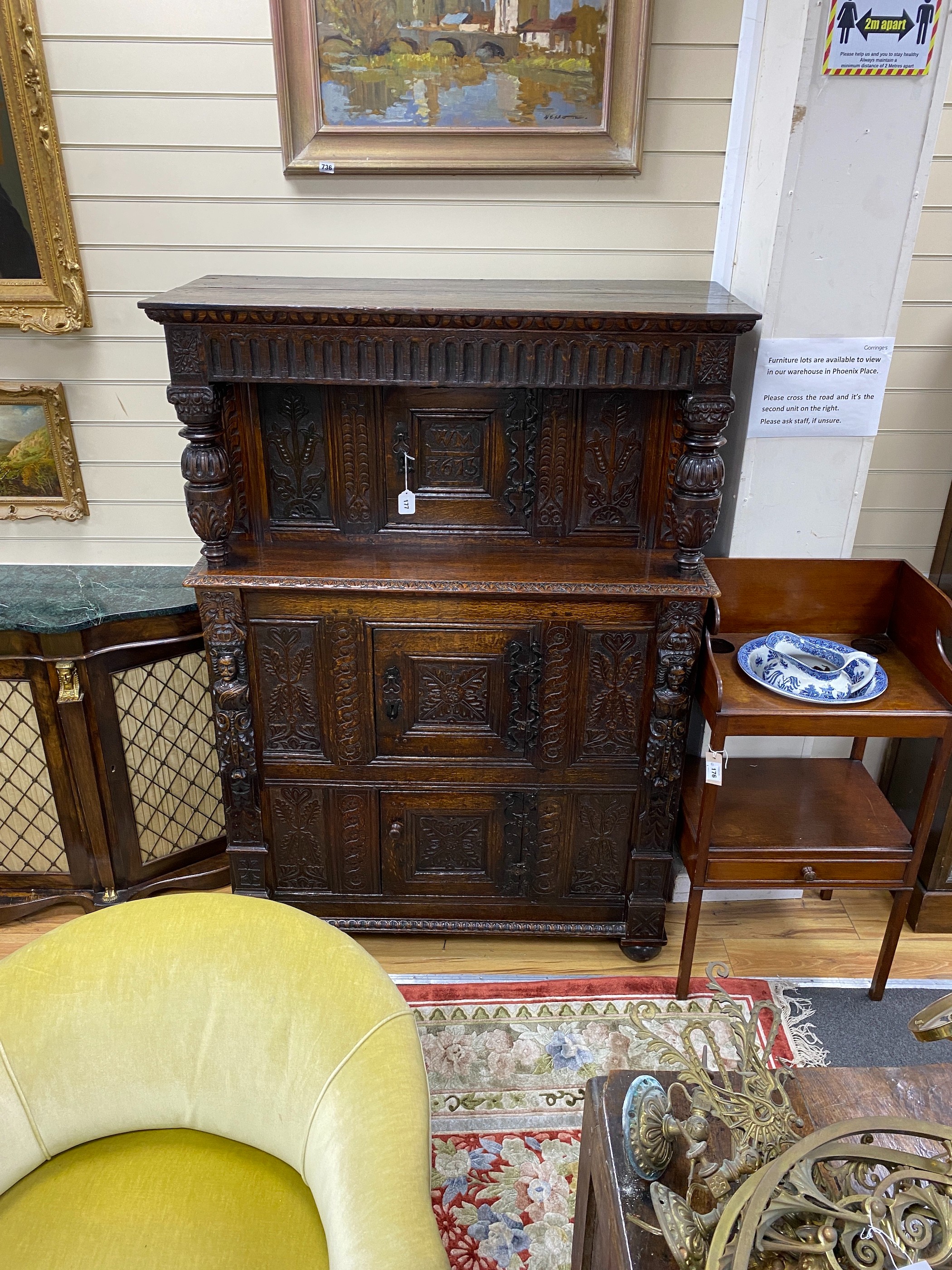 A 17th century carved oak press cupboard, width 112cm, depth 51cm, height 159cm